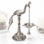 Handcrafted Silver Finish Peacock Hanging Diya with Bell – Decorative Oil Lamp for Pooja & Home Temple